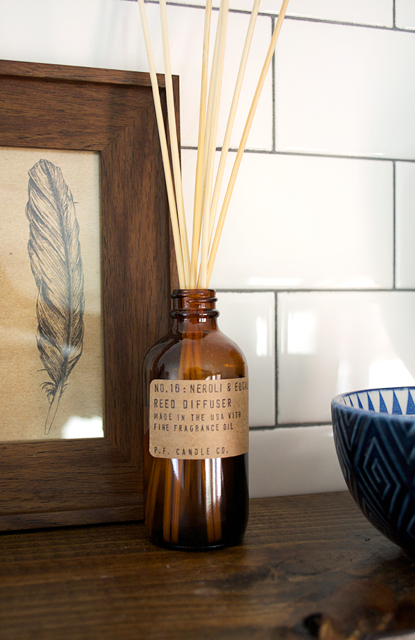 brown bottle reed diffuser in laundry room