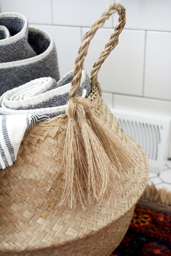 A Belly basket with tassels for holding towels