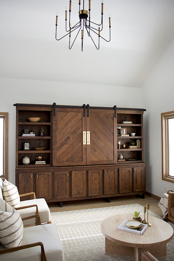 Wood entertainment center with sliding barn doors and brass hardware