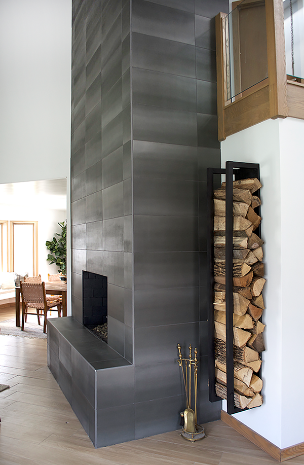 Concrete tile fireplace with floating wood rack