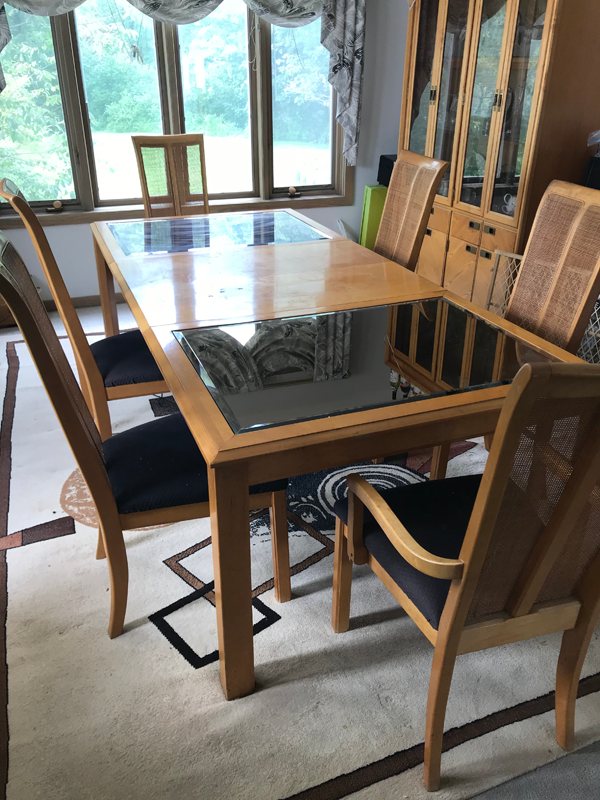 A dated dining room table with a mirror top