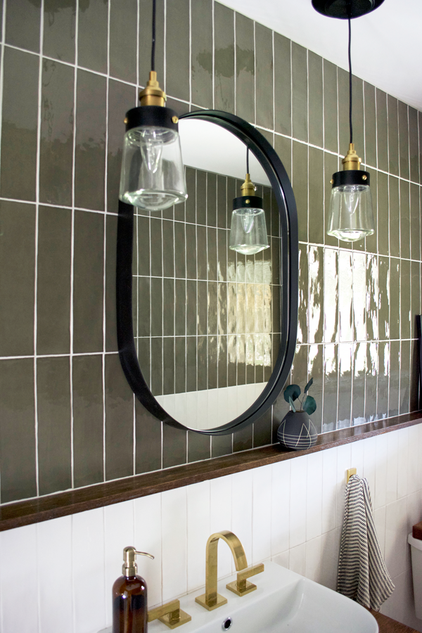 Black Oval Mirror Above Bathroom Vanity