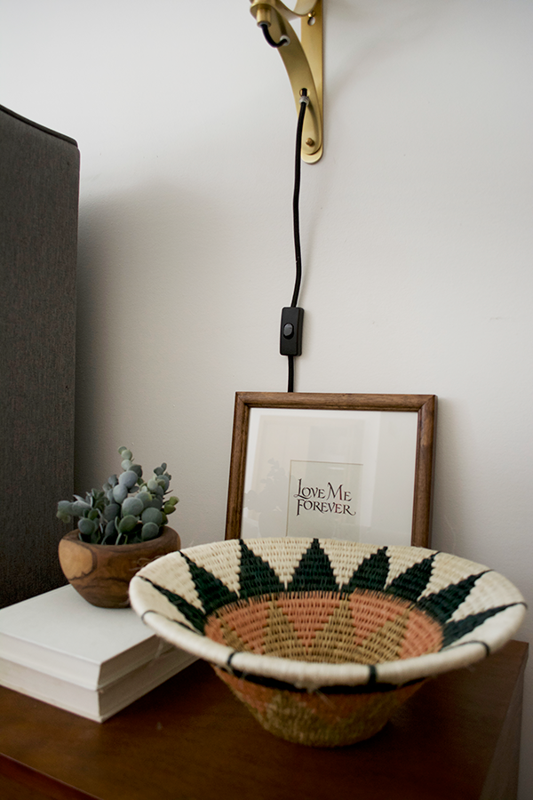 Styling a nightstand with a wall sconce
